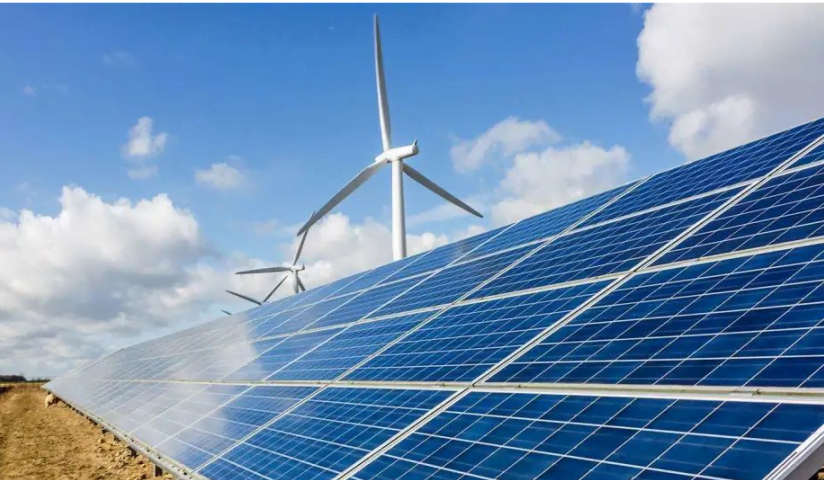 Solar PV Equipment and wind turbines under a partly cloudy sky, generating renewable energy.