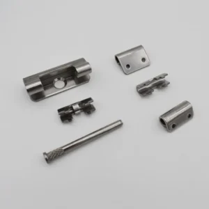 The product named 1-0 is displayed on a white surface, featuring various silver metal components such as a rod, hinges, and small bracket-like pieces.