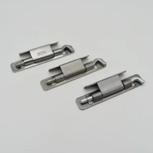 Three metal toggle latches, identified as 107-0, feature silver finishes, rectangular bases, and come with screws. They are arranged diagonally on a plain gray background.