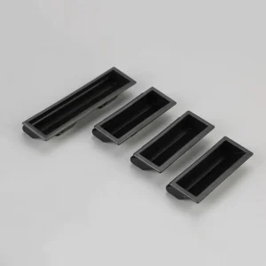 Four 144-0 black, rectangular recessed pull handles of varying sizes arranged in a row on a gray surface.