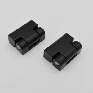 Two 24-0 black plastic connector components with a rectangular shape and circular features on a plain white background.