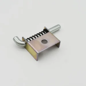 The 84-0 product features a metallic spring-loaded pin latch mechanism with a rectangular base, a protruding pin, and a curved latch, all set against a plain white background.