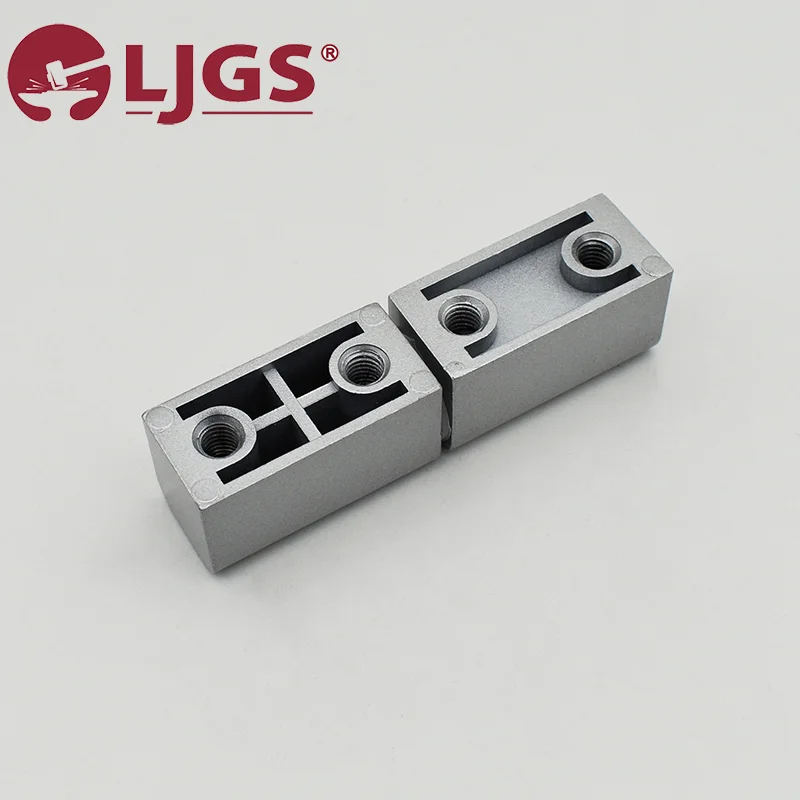 Two rectangular components made of Zinc Alloy, featuring threaded holes and geometric cutouts, are positioned side by side on a plain background. These components are the CL203-2 (3).
