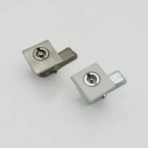 DSC_2317 showcases a pair of square cam locks featuring sleek metal finishes, artfully displayed against a simple white backdrop.
