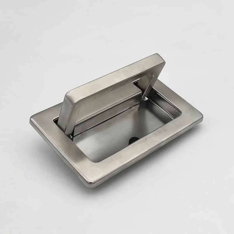 The bbf37055dc3577002c68446588a94c4 is a rectangular metal handle mounted on a flat surface, designed for pulling or lifting.